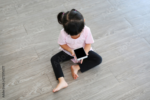 Little girl playing smartphone.