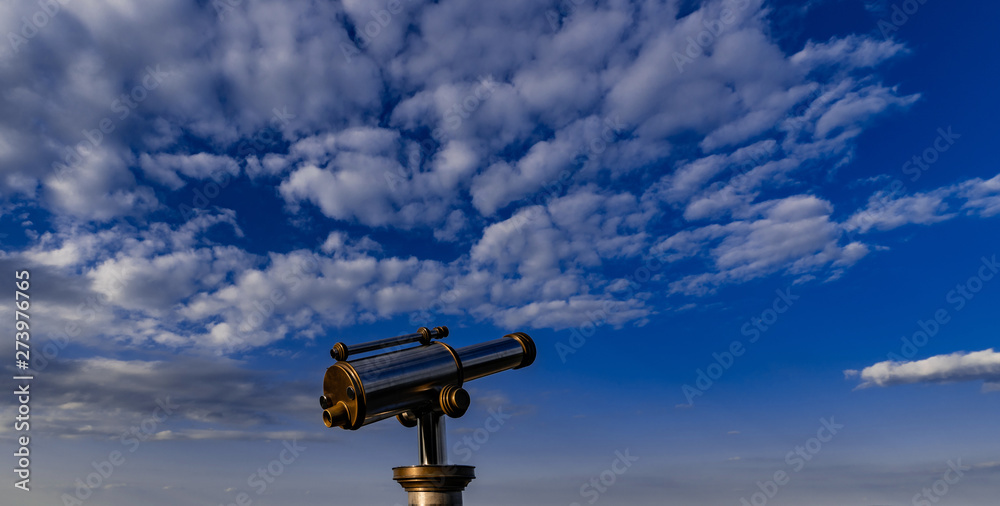 Refracting telescope with cloudy sky