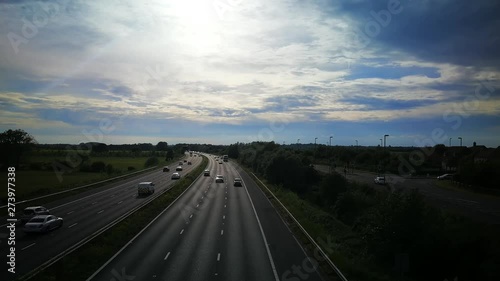 A countryside shot of a motorway in the evening with cars photo