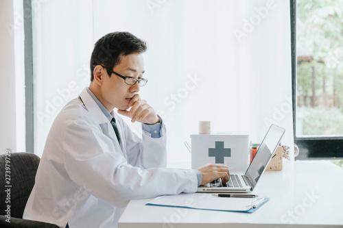 Male doctor use computer,research and analyze,Disease analysis,and record patient information,Concept using technology for medical benefits and data collection