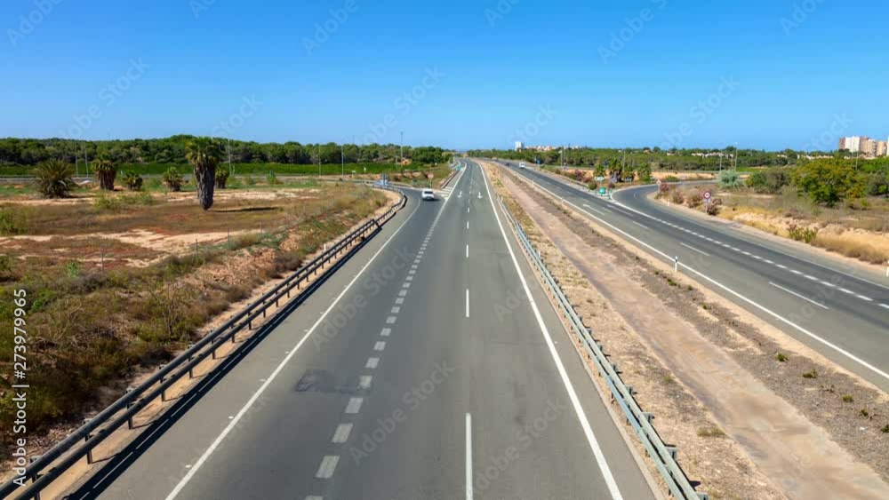 A time lapse shot of the AP7 motorway in Spain near Torrevieja in the sunshine and blue sky. Location on a highway bridge. A time lapse shot of the AP7 motorway in Spain near Torrevieja in the sunshine and blue sky. Location on a highway bridge.