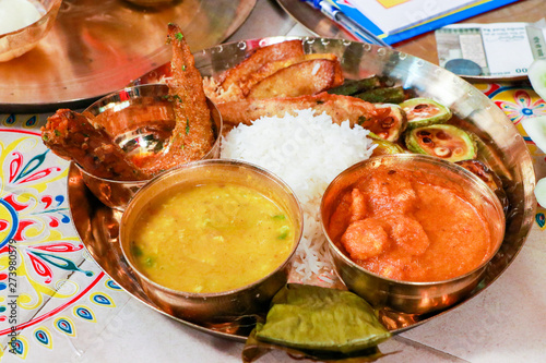 traditional Indian food in thali with curry, rice ,fish and chiken