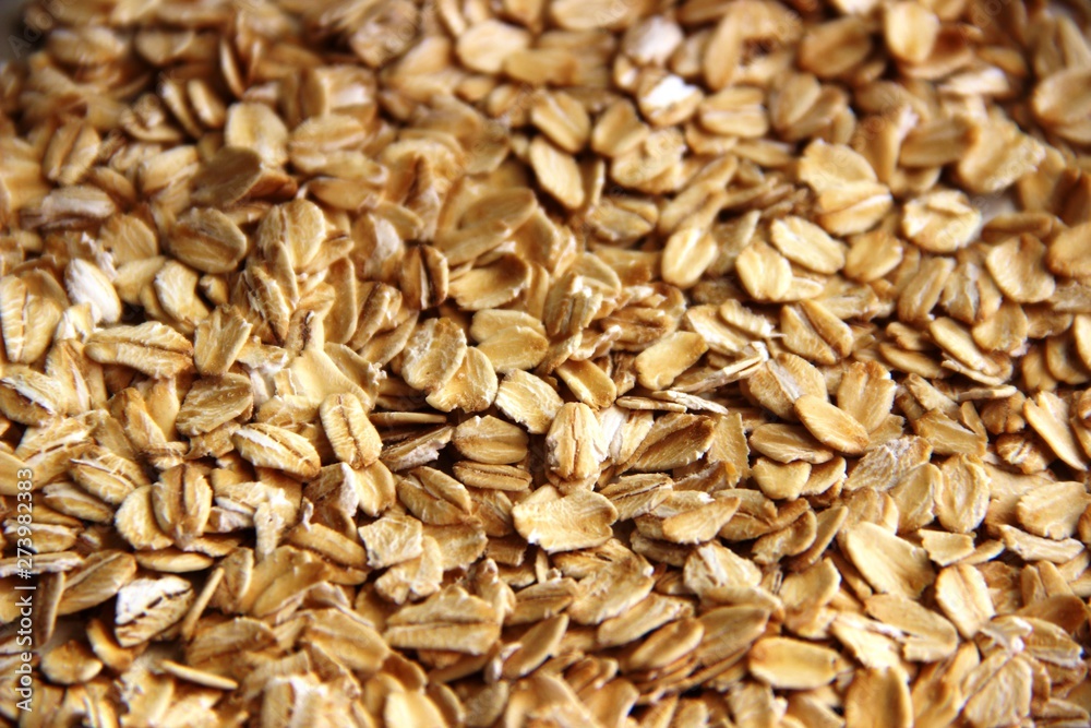 Lots of oatmeal or oat flakes as background. concept Useful oat flakes gluten free Lots of oatmeal or oat flakes as background. concept Useful oat flakes gluten free