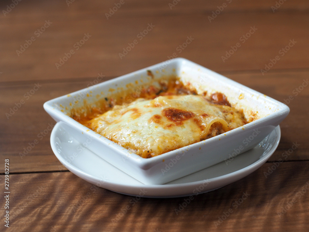 Baked spinach with cheese on wooden table. Baked spinach with cheese on wooden table.