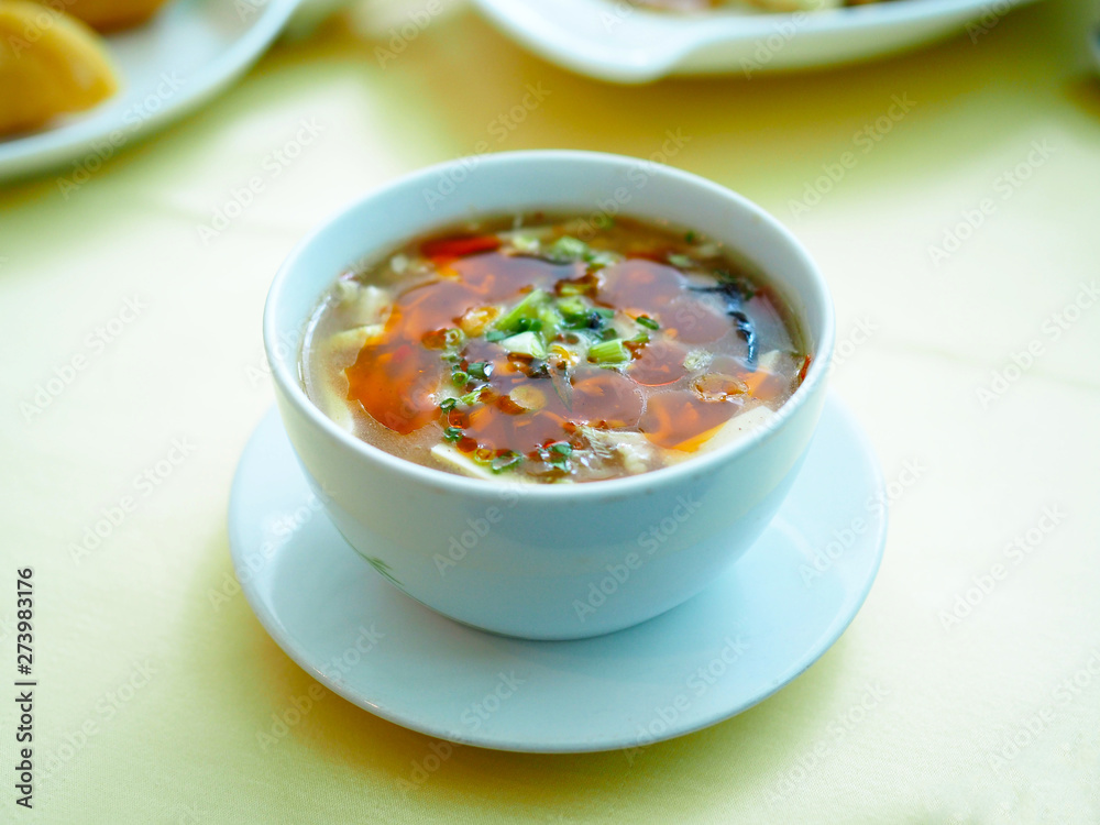 White bowl of hot and sour Sichuan style, Chinese traditional food. Selective focus. White bowl of hot and sour Sichuan style, Chinese traditional food. Selective focus.