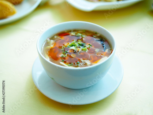 White bowl of hot and sour Sichuan style, Chinese traditional food. Selective focus.