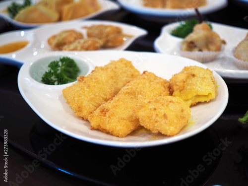 Deep fried bean curd stuffed with shrimp served with sweet and sour plum sauce. Selective focus.