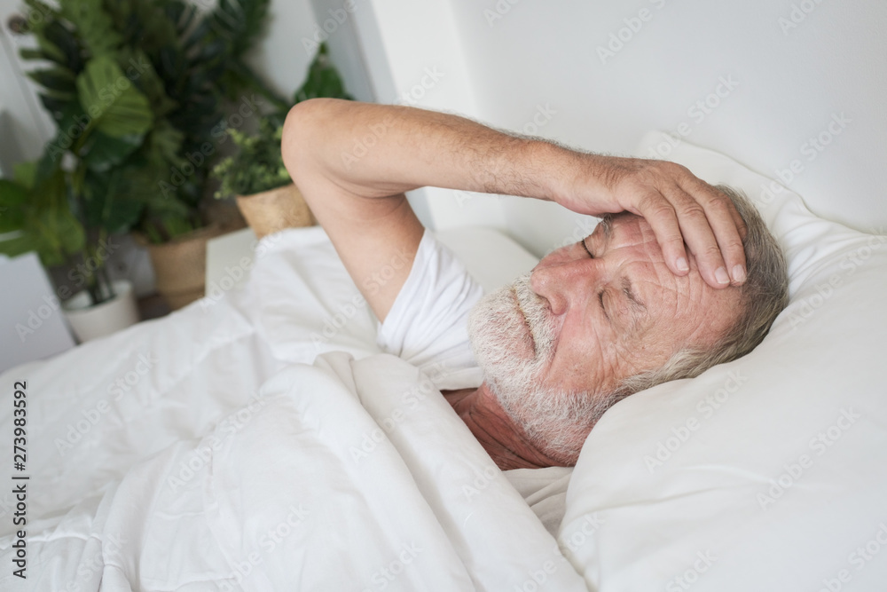 senior man sleeping alone and headache or dreaming nightmare on bed in room senior man sleeping alone and headache or dreaming nightmare on bed in room