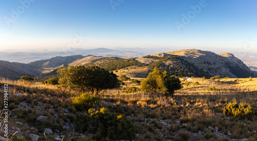 This mountain region is called Sierra Espuna. A panoramic view at sunset from the summit of Mount Morron in the Spanish region of Murcia to the north. photo