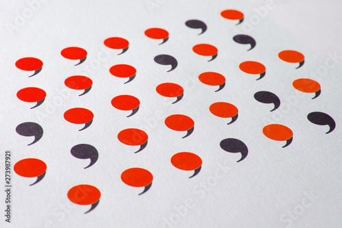 black comma in many red commas.