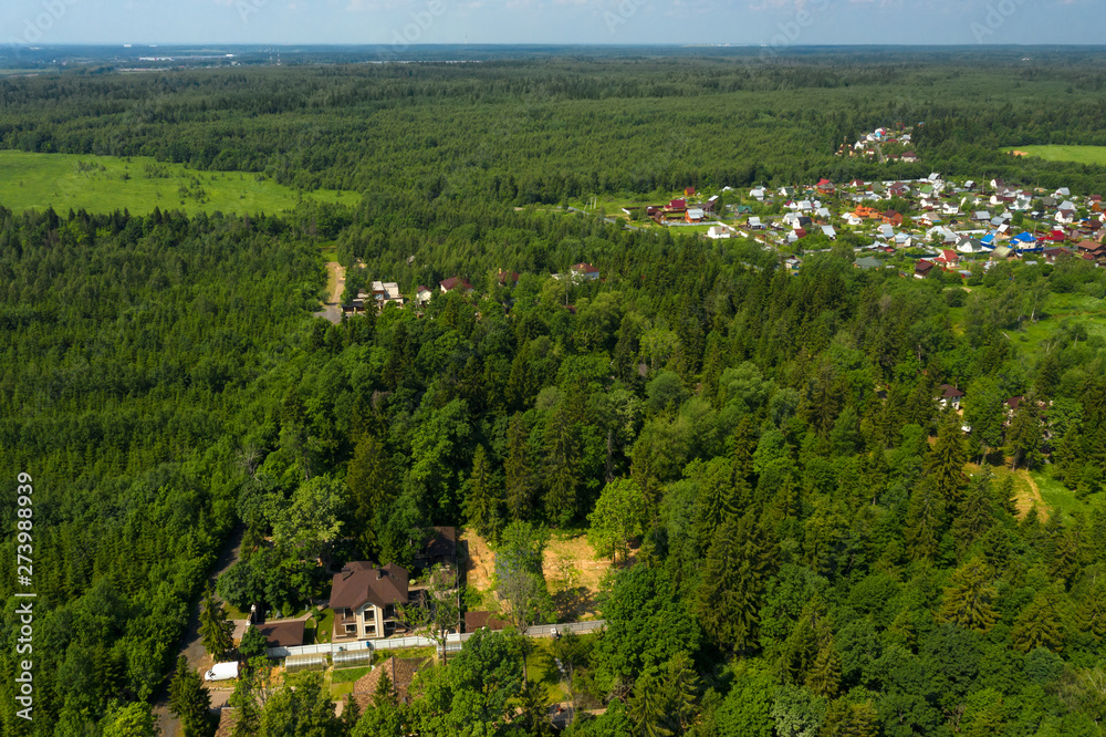 Aerial view on the countryside and the village  on the horizon on a summer day