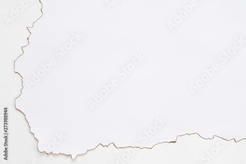 Cropped flat lay of burnt paper on white surface. Blank manuscript design. Abstract background. Copy space.