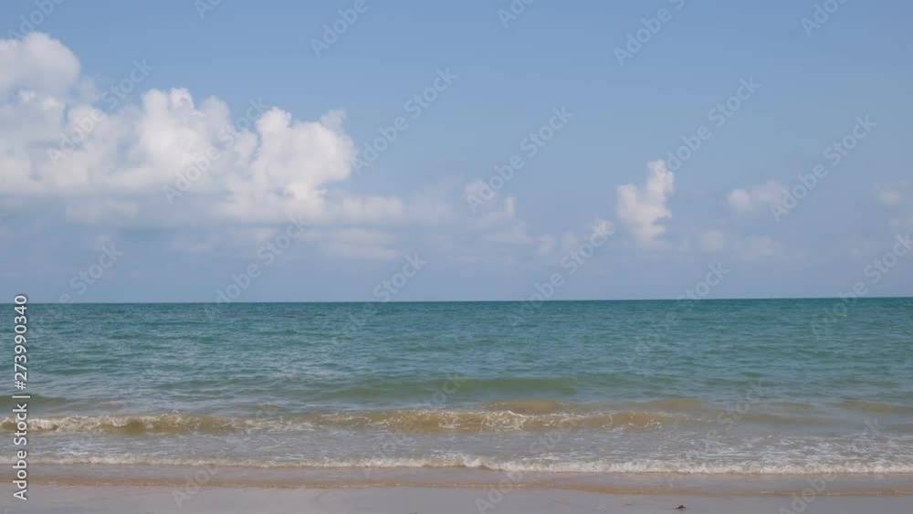 lue sky with white clouds over the calm sea with white waves in the summer. lue sky with white clouds over the calm sea with white waves in the summer.