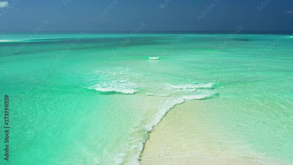 Aerial perspective of calm waves, breaking in shallow turquoise water. On a sandbank in the Philippine Sea. wide angle, static. Aerial perspective of calm waves, breaking in shallow turquoise water. On a sandbank in the Philippine Sea. wide angle, static.