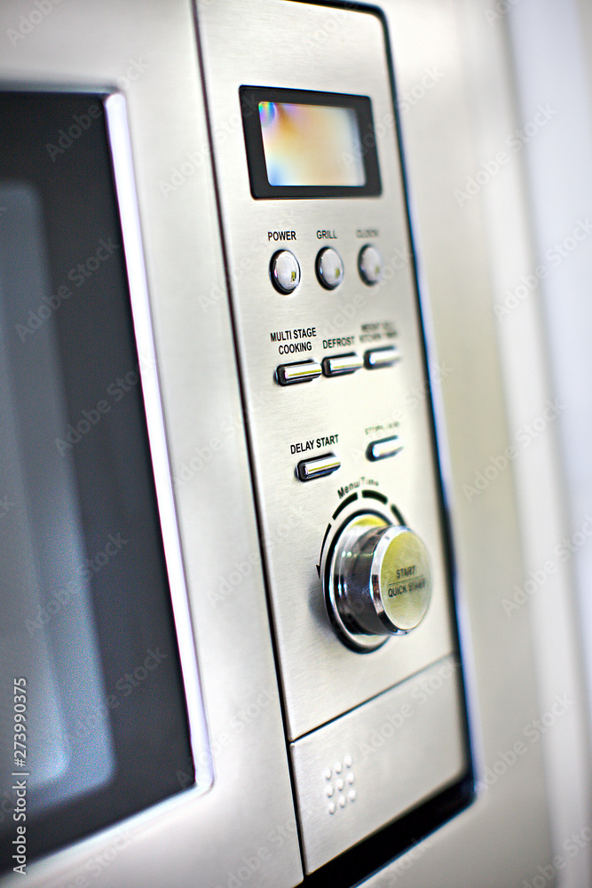 Modern oven control panel close up with buttons and knob Modern oven control panel close up with buttons and knob