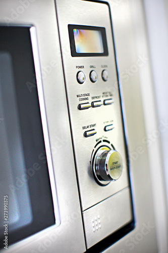 Modern oven control panel close up with buttons and knob