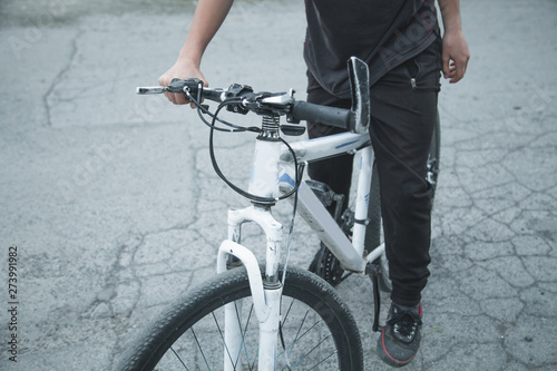 Caucasian boy riding bicycle at asphalt.