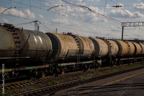 a train loaded with cisterns goes by rail