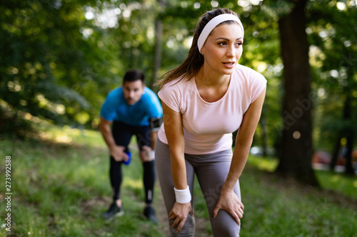 Exhausted fit couple runners after fitness running workout outdoors