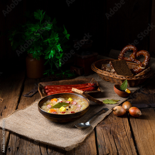 rustic sauerkraut soup with bacon and sausage photo