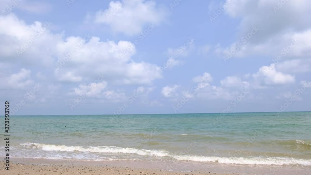 lue sky with white clouds over the calm sea with white waves in the summer. lue sky with white clouds over the calm sea with white waves in the summer.