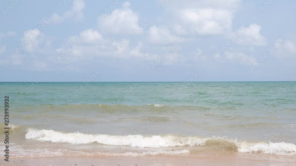 Blue sky with white clouds over the calm sea with white waves in the summer. Blue sky with white clouds over the calm sea with white waves in the summer.