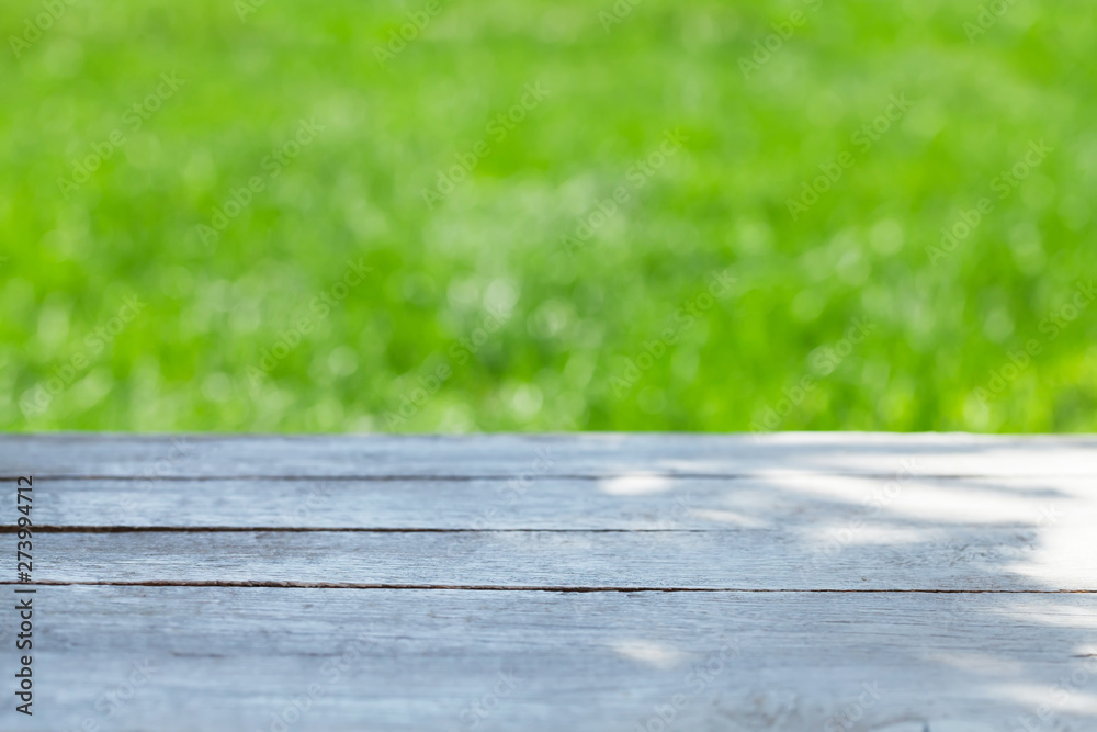 Empty wooden table over bokeh natural background