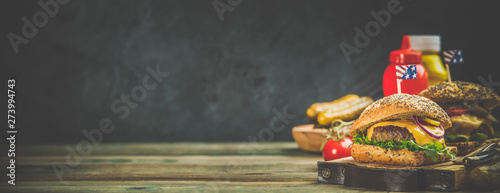 Homemade hamburgers on wooden background, space for text