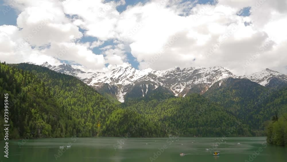 In a small beautiful lake in the mountains of Abkhazia floating boats and catamarans In a small beautiful lake in the mountains of Abkhazia floating boats and catamarans