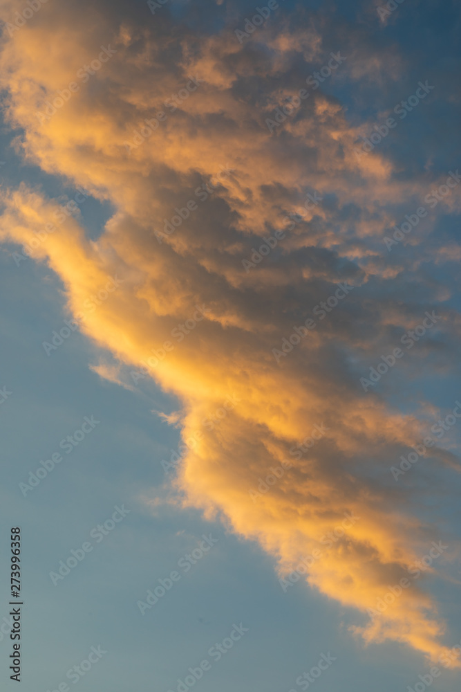 Sunset clouds on the sky with orange colors