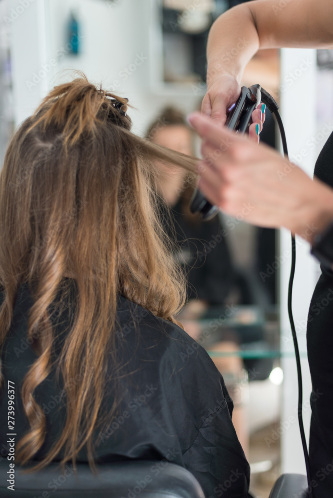 Fototapeta premium Young woman in hairdressing salon