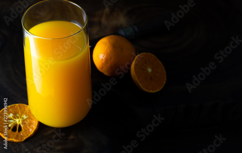 Fresh healthy orange juice, smoothie in a glass on wooden background. summer concept.