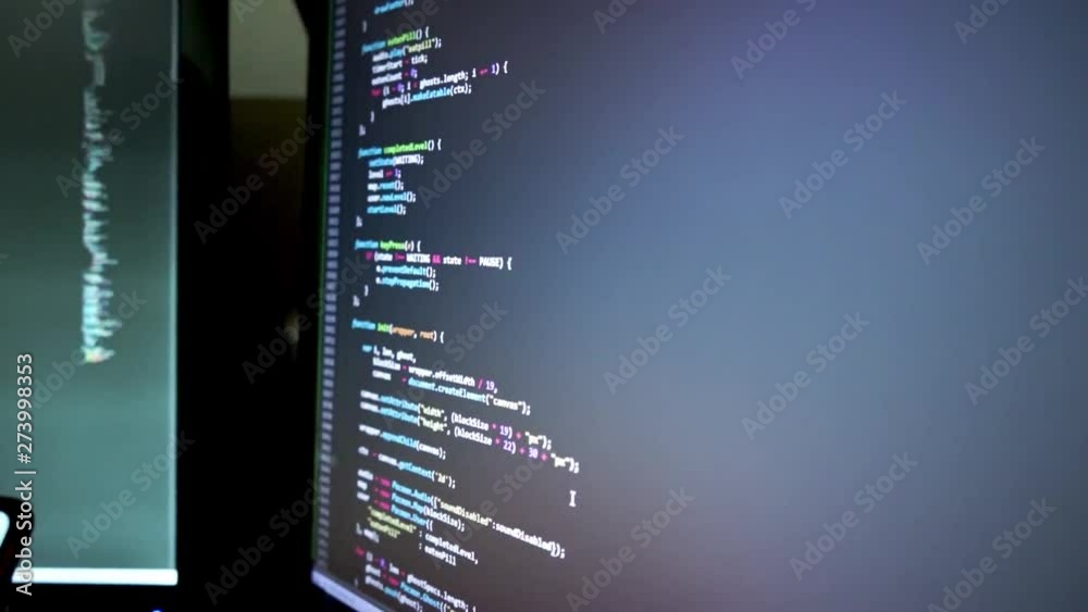 This footage depicts a parallel viewpoint to a monitor showing code on ...