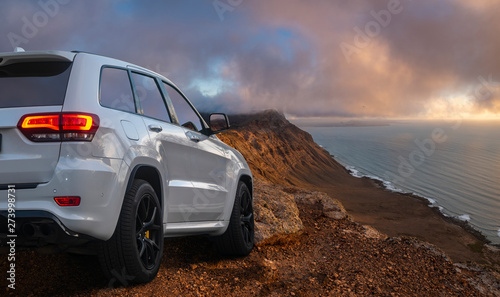 SUV driving on mountain off-roads photo