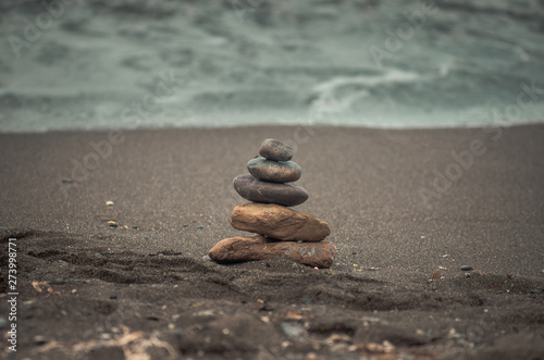 Canvas Print stack of stones on the beach