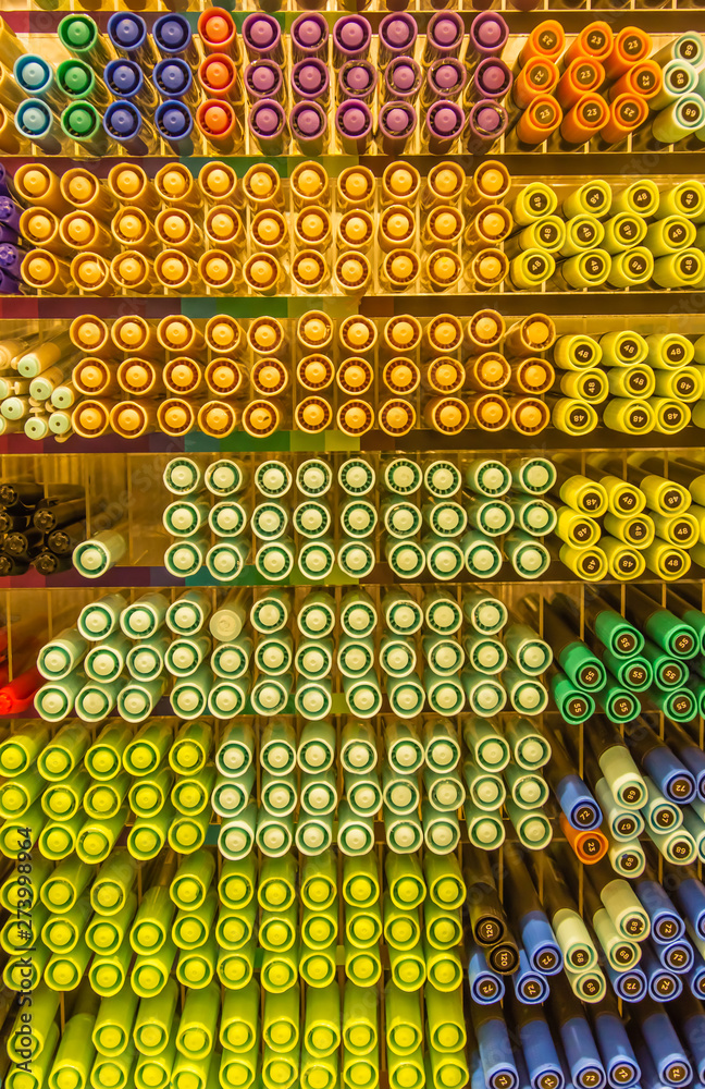 several color pens stack row in stationary shop background