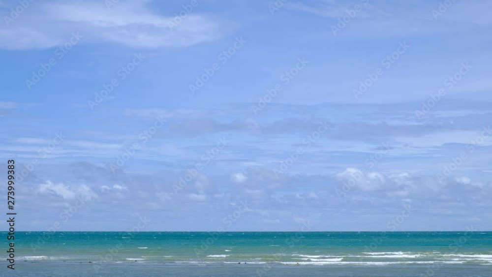 lue sky with white clouds over the calm sea with white waves in the summer. lue sky with white clouds over the calm sea with white waves in the summer.