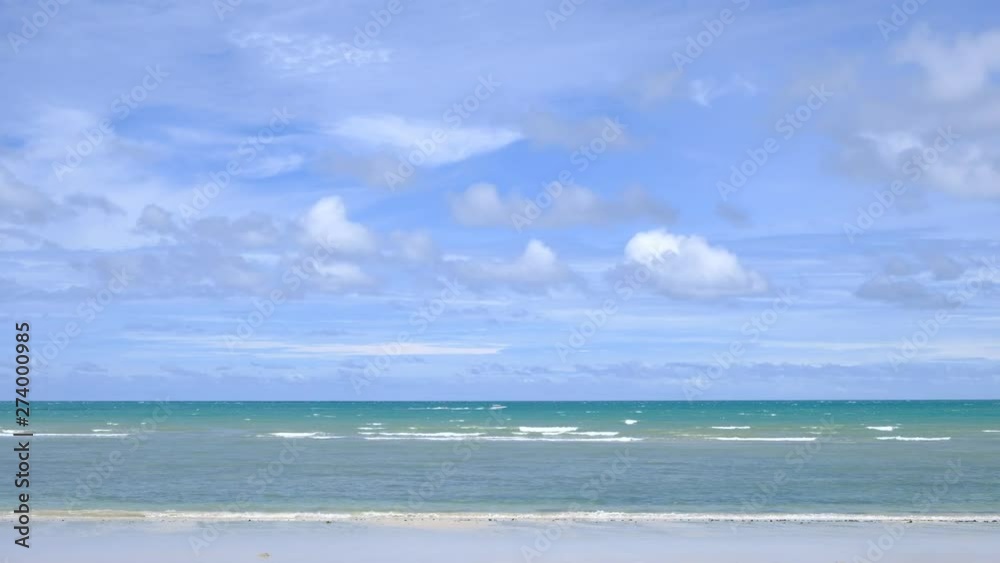 lue sky with white clouds over the calm sea with white waves in the summer. lue sky with white clouds over the calm sea with white waves in the summer.