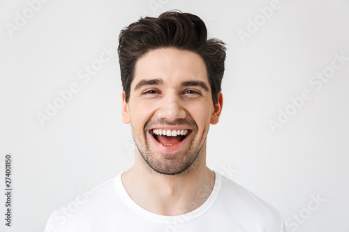 Happy young excited emotional man posing isolated over white wall background.