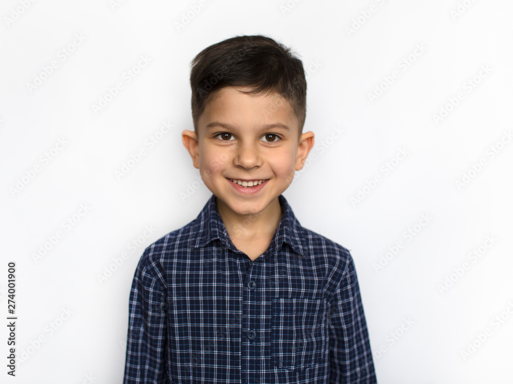 portrait of a cute little smiling boy in a blue shirt, isolated on a white background portrait of a cute little smiling boy in a blue shirt, isolated on a white background