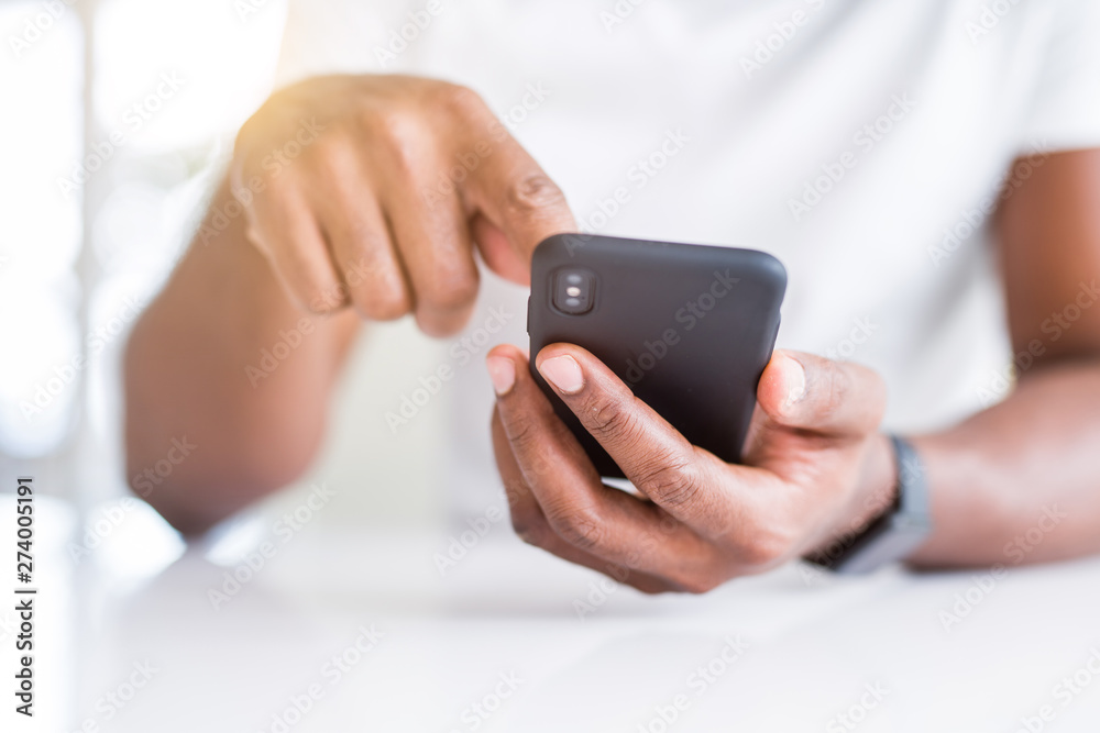 Close up of african american man hands using smartphone Close up of african american man hands using smartphone
