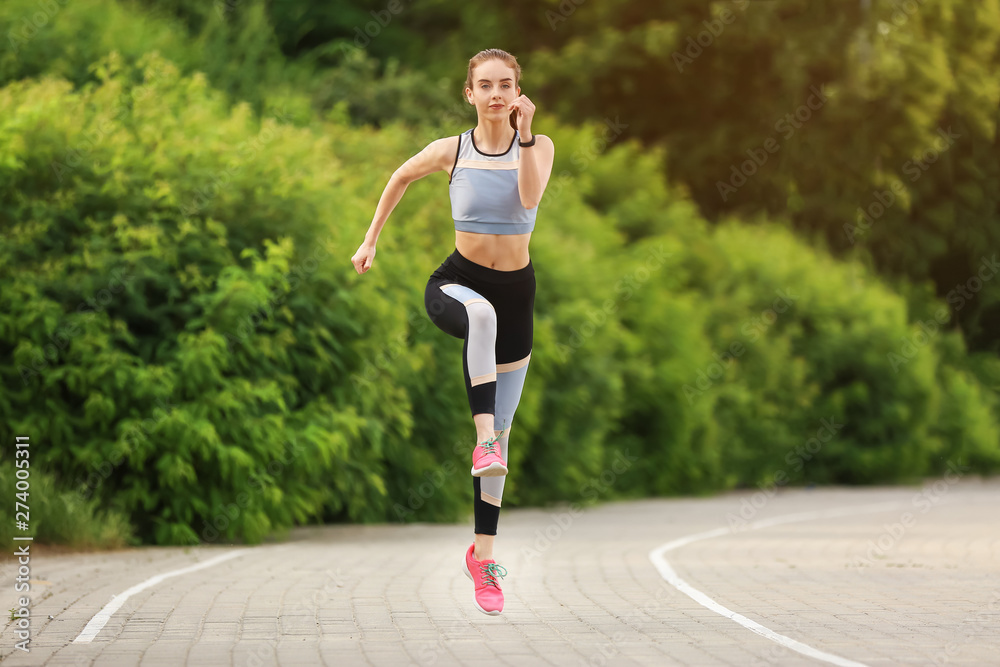 Sporty young woman running in park Sporty young woman running in park