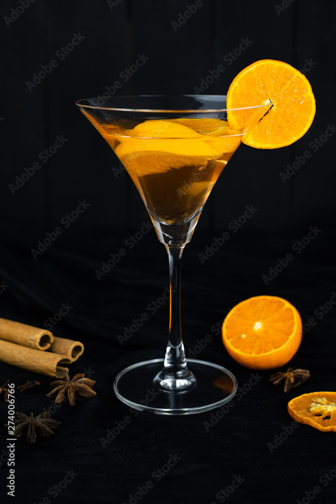 orange cocktail, Christmas hot drink in glass with orange, cinnamon, star anise, Clove.