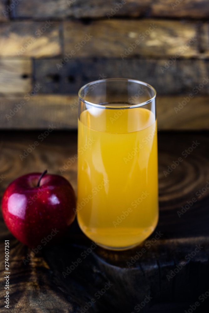 apple juice in a glass on wooden background apple juice in a glass on wooden background