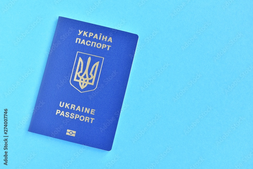 Biomedical Ukraine id passport on bright blue background with selective  focus and empty space for photo or text. Ukrainian id passport with a  golden symbol trident on blue backdrop. Copy space Stock