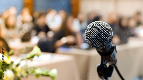 Microphone for speaker describing abstract blurs in seminar room or lectures for audiences in business hall.