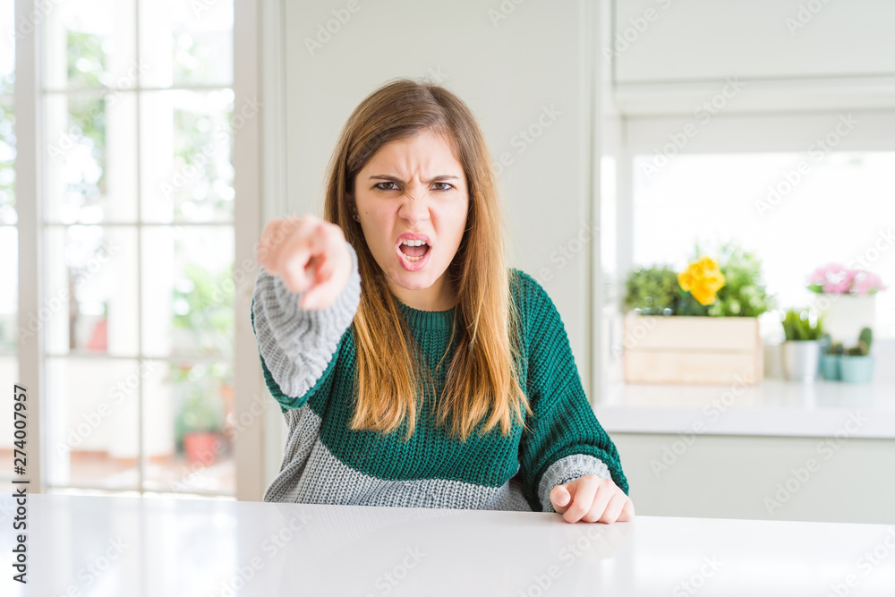 Young beautiful plus size woman wearing casual striped sweater pointing displeased and frustrated to the camera, angry and furious with you Young beautiful plus size woman wearing casual striped sweater pointing displeased and frustrated to the camera, angry and furious with you