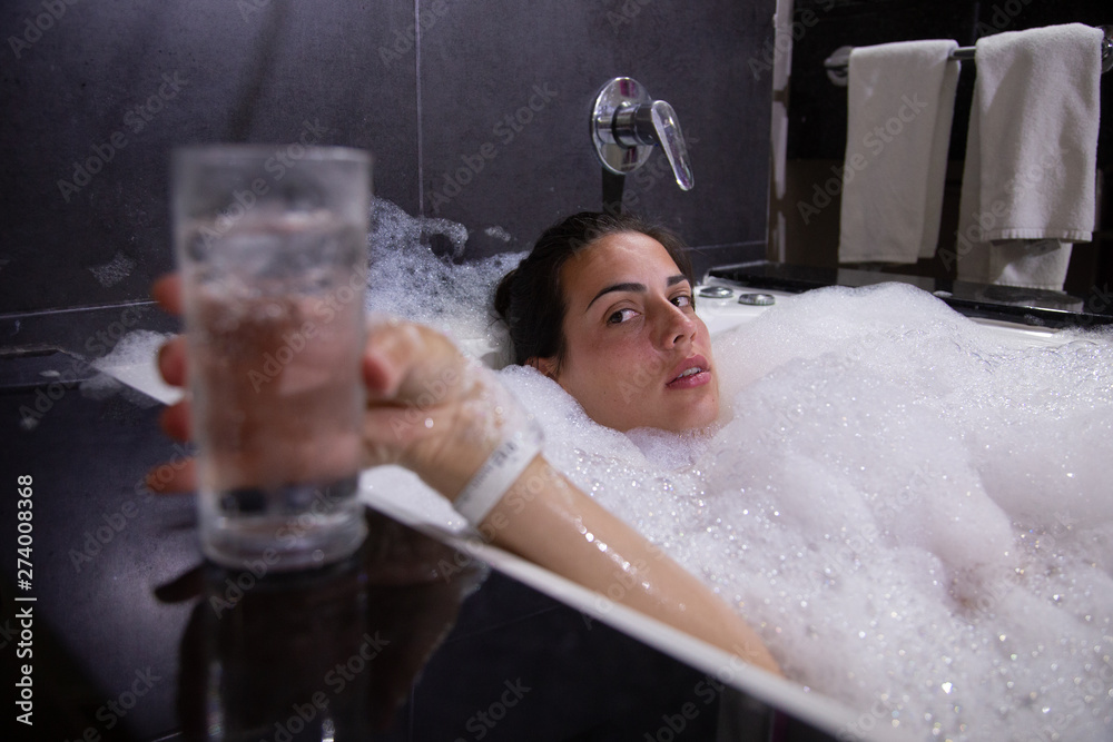 Woman taking a bath of foam in bathtub