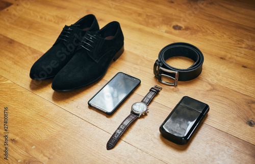 different accessories of a businessman for creating a style of a people lie on a wooden background