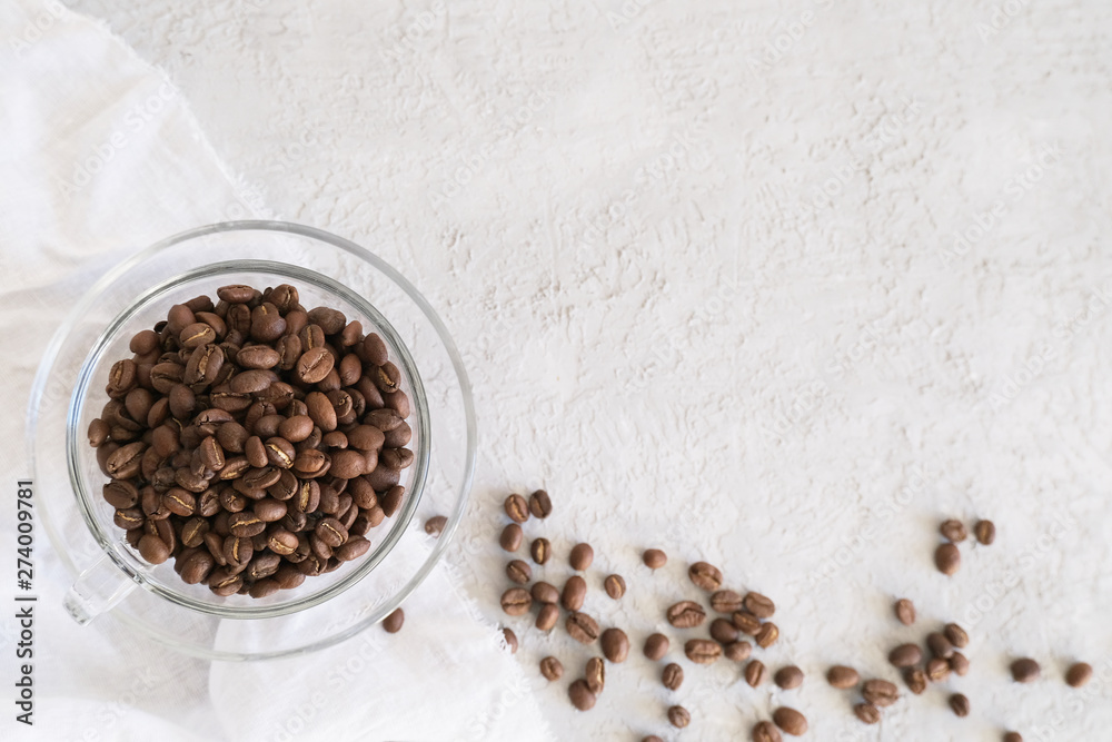 Aroma frame fot text made of glass cup coffee beans on gray background with copyspace. Flat lay, top. view. Beverages, morning and cafe concept